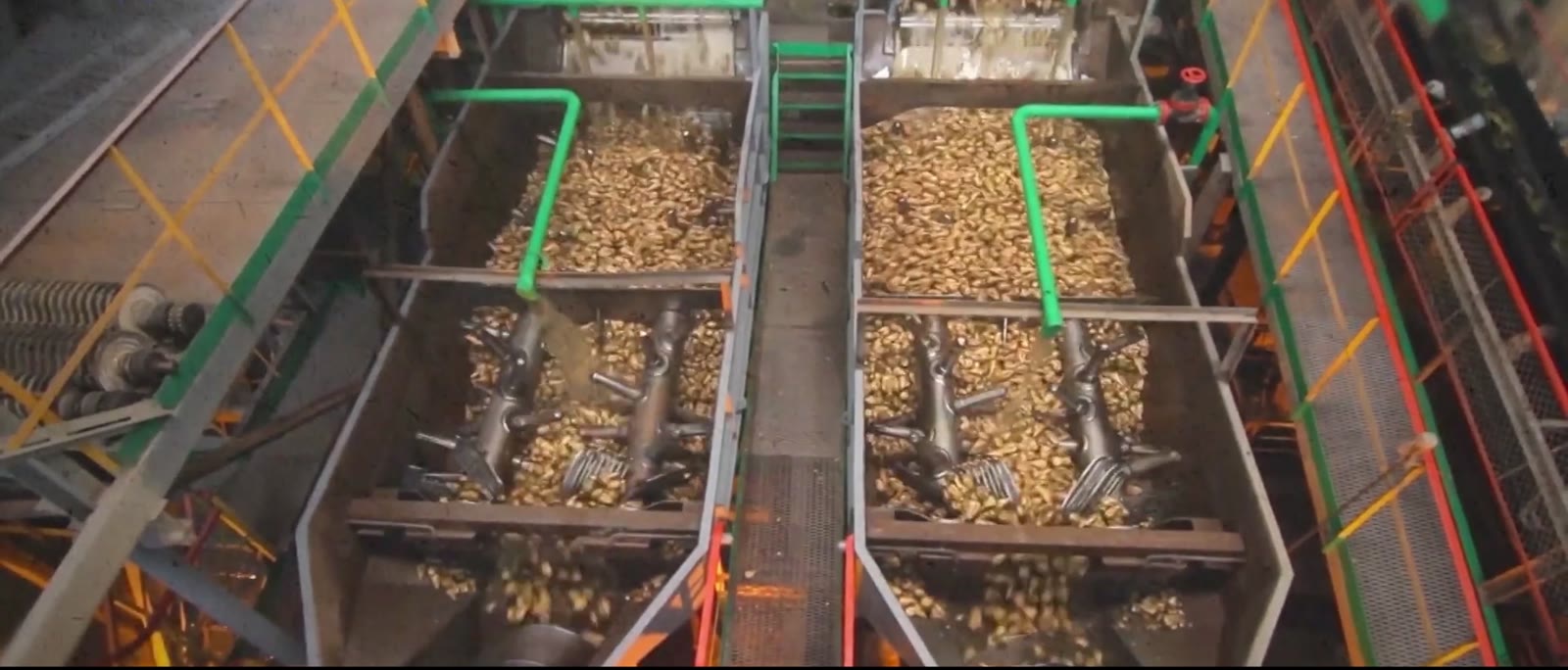 Recovered material moving through twin feed hoppers on a Bollant processing line