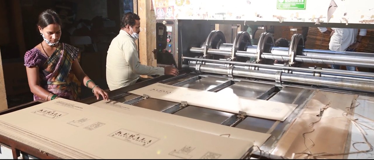 Operator feeding board through a converting line at a Bollant unit