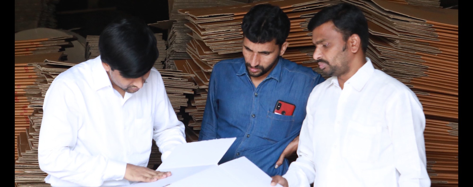 Bollant leaders reviewing a specification on the production floor