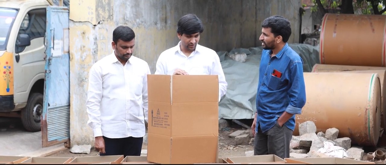 Bollant team with a finished carton and kraft paper reels at a unit